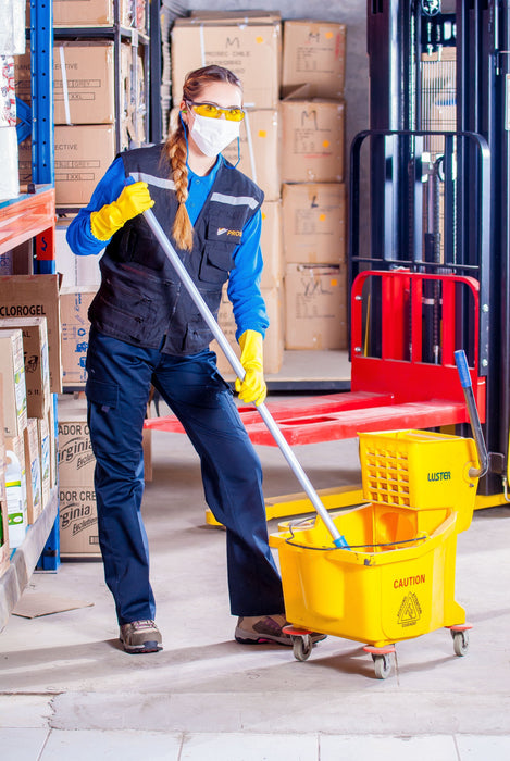 Janitor cleaning a warehouse floor