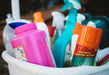 Assorted cleaning supplies in a bucket