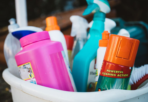 Assorted cleaning supplies in a bucket