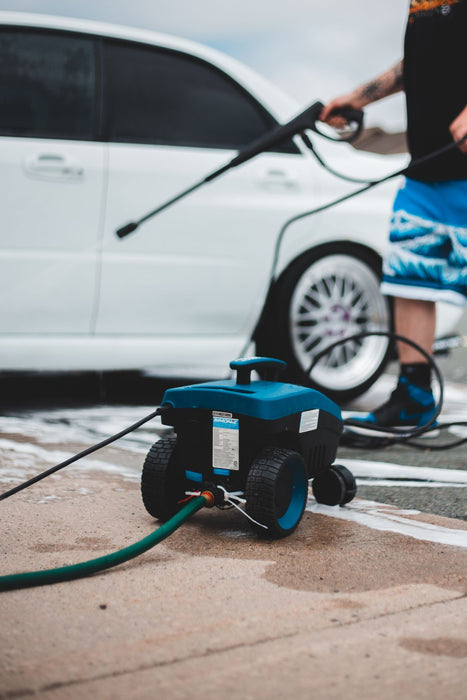 Electric pressure washer with hose in use