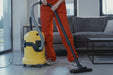 Professional cleaner using a commercial upright vacuum