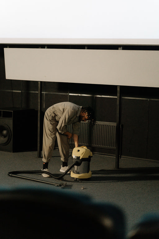 Worker using commercial cleaning equipment on a floor
