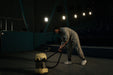 Worker vacuuming carpet in a commercial cinema setting
