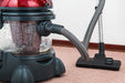 Portable carpet spot extractor vacuum on carpet floor